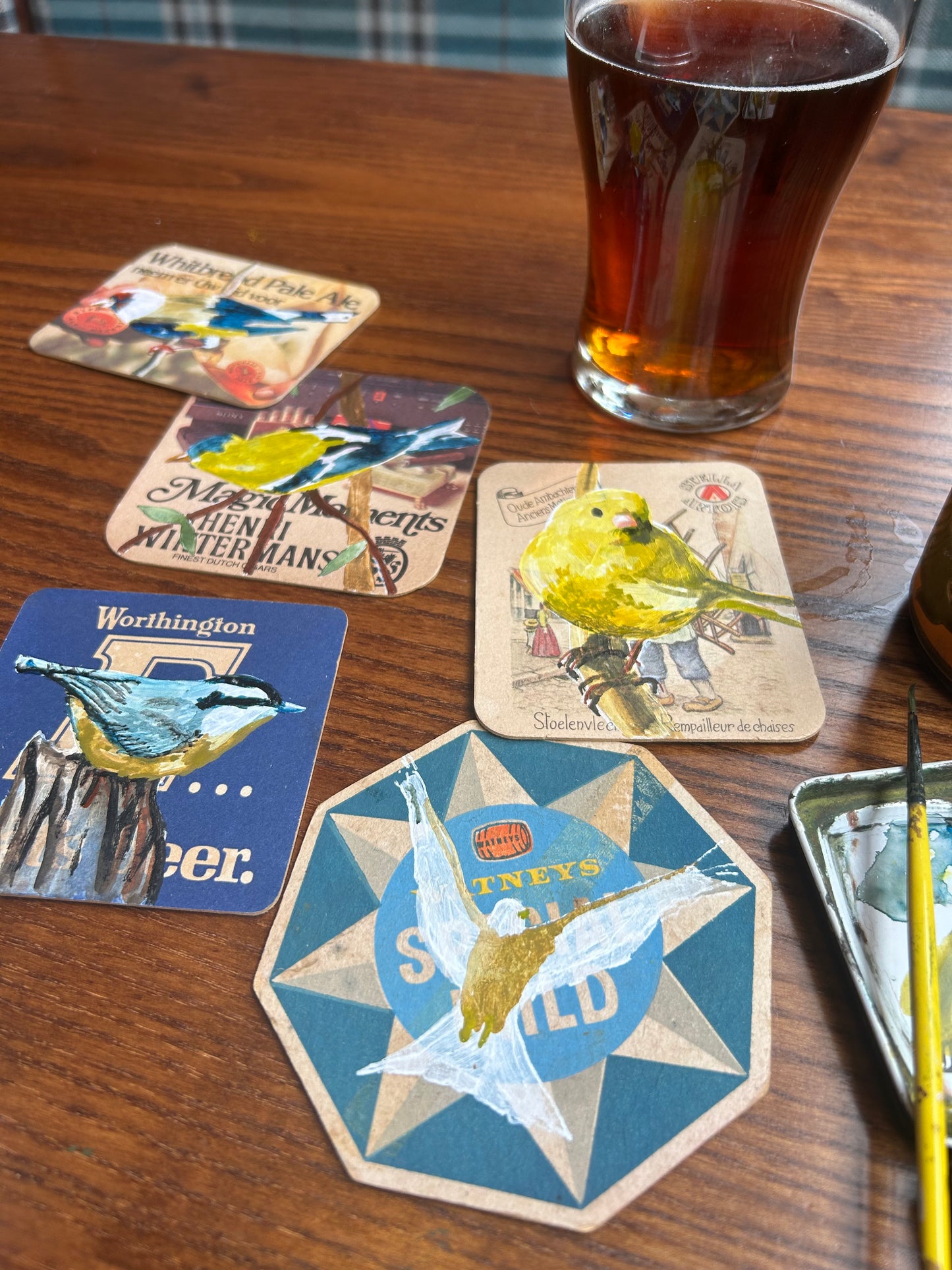A Canary painted onto a Stella Artois beer mat. Beer mat painting. Watercolour.