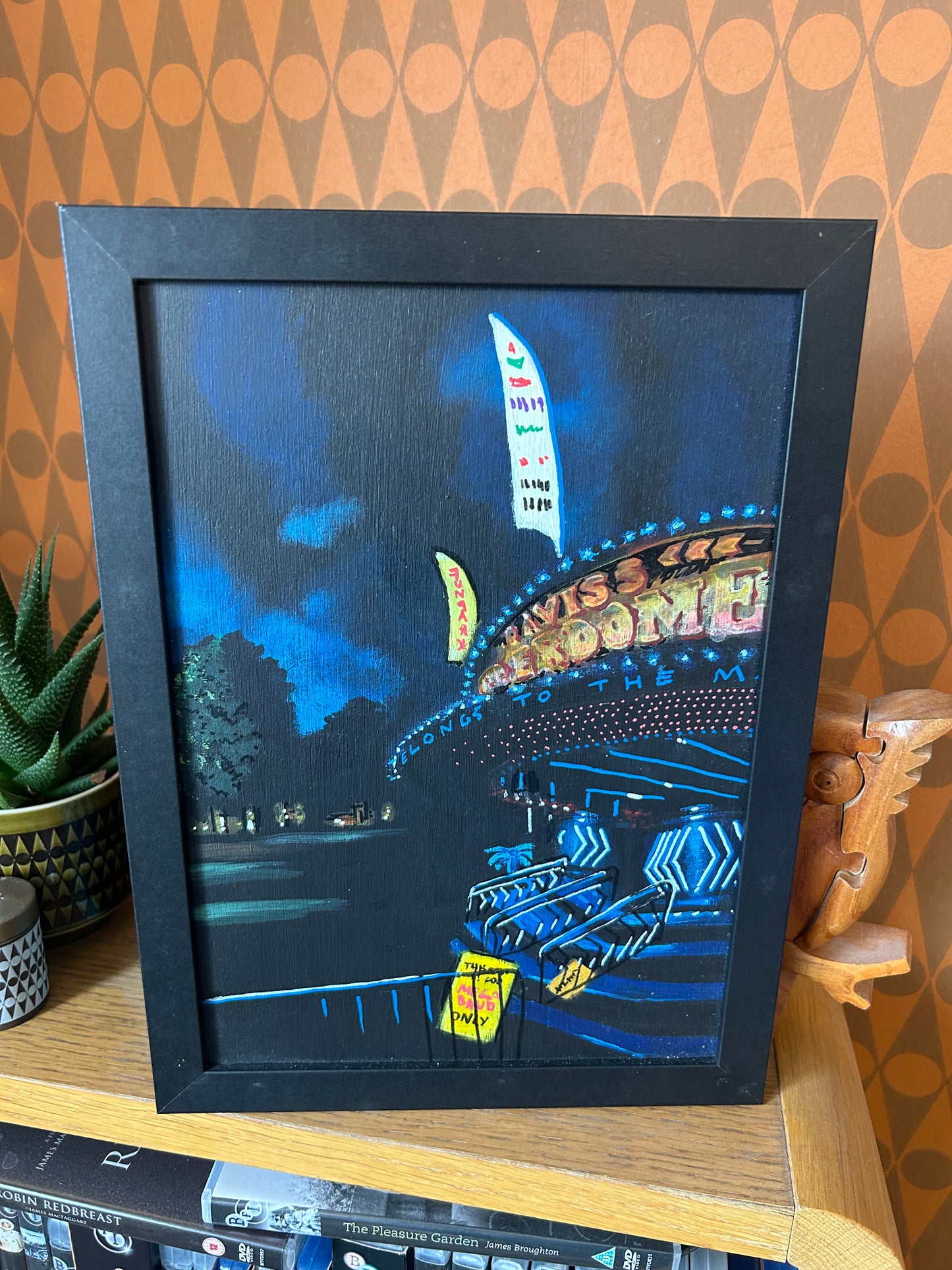 ‘Let’s leave the subtitles on’ A4 night painting. Acrylic on board. Framed. Fun Fair 2024 02