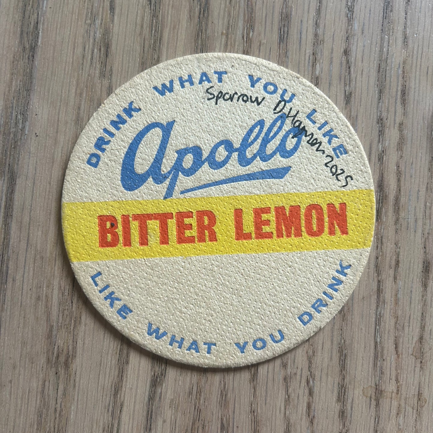 A sparrow painted onto an Apollo Fruit Drinks drinks mat from the 1950s. Beermat painting. Watercolour.
