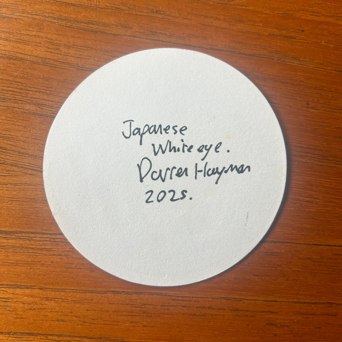 A Japanese White Eye painted on a beer mat from Hiroshima Neighbourly Brewing. Beermat painting. Watercolour.
