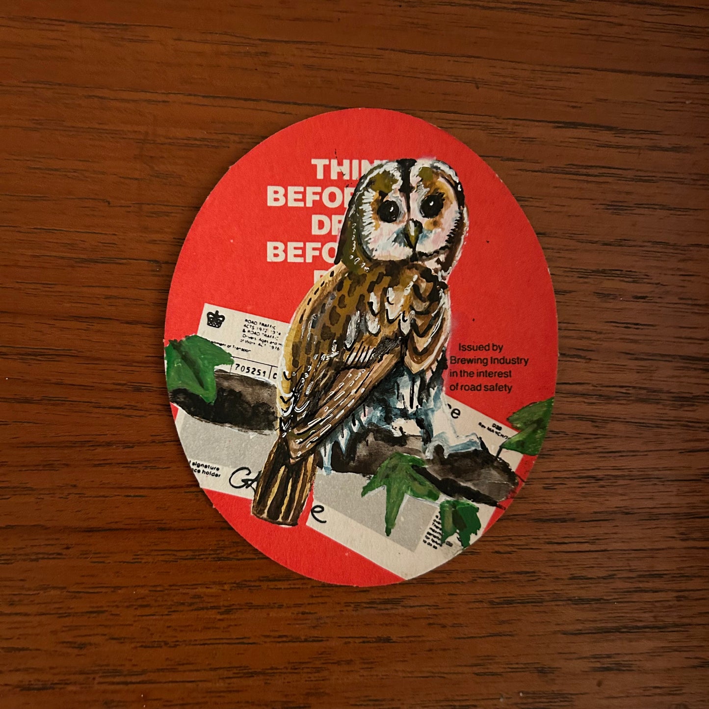 A Tawny Owl painted onto a drink/drive Whitbread beer mat from the 1970s. Beermat painting. Watercolour.