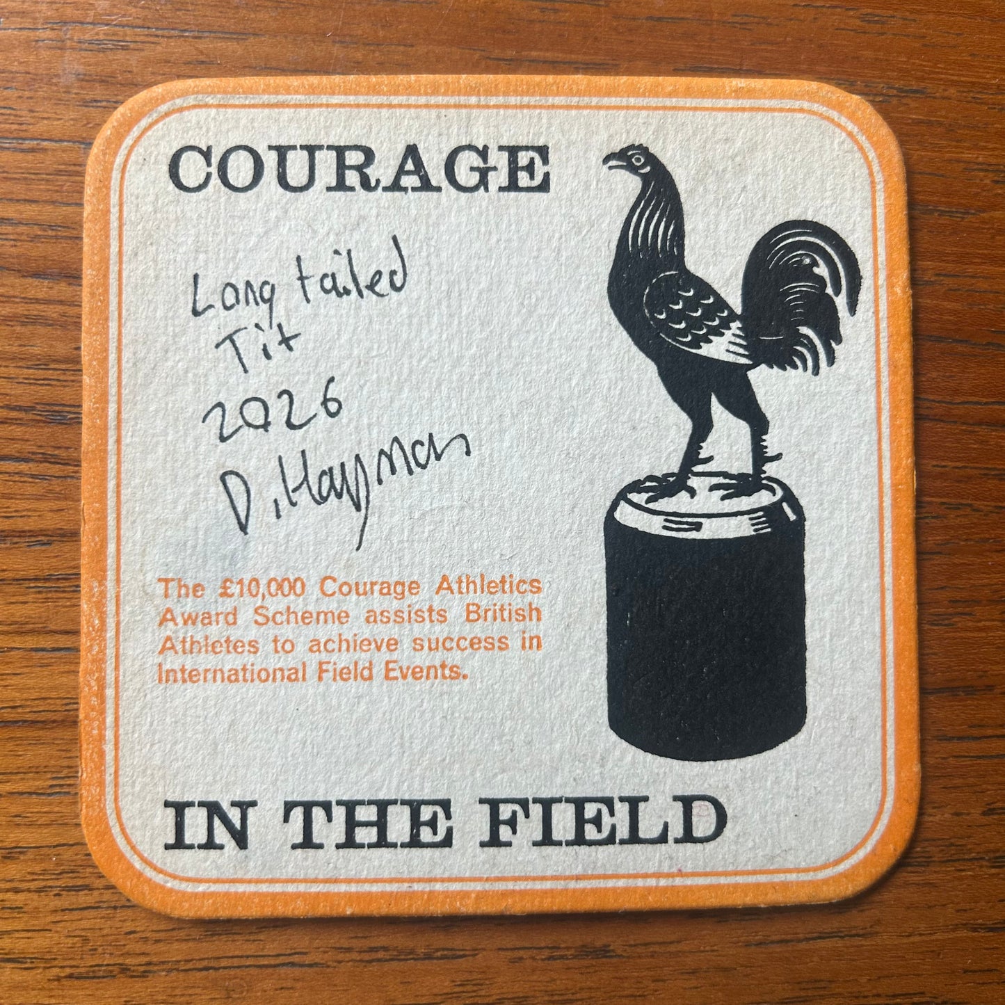 A Long Tailed Tit painted onto a Courage Beer ‘In The Field’ athletics beer mat from 1964. Beermat painting. Watercolour.