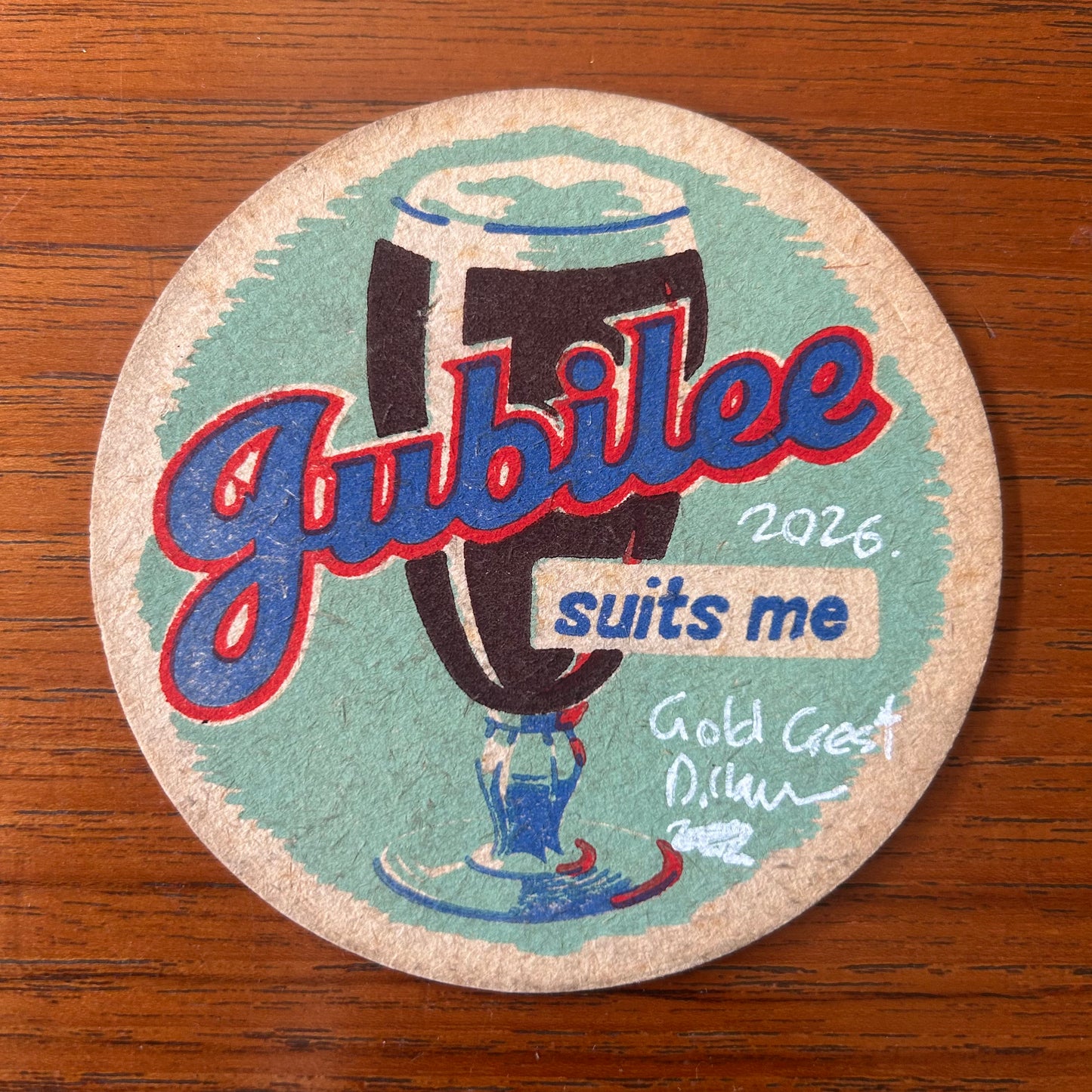 A Gold Crest painted onto a Jubilee Stout beer mat from the 1950s. Beermat painting. Watercolour.