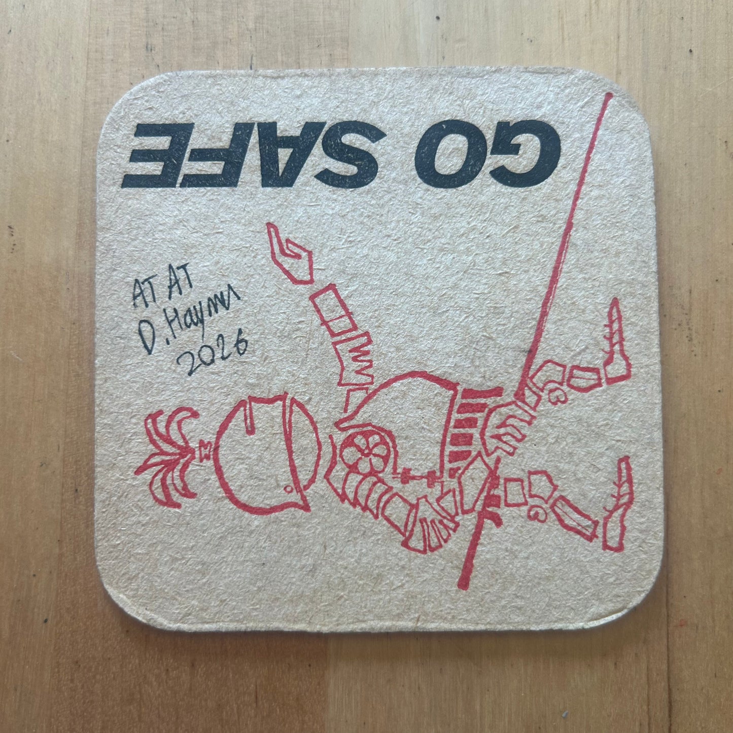 Two AT-ATs painted on a ‘Stop Accidents’ Beermat from the 1950s. Beermat painting. Watercolour.
