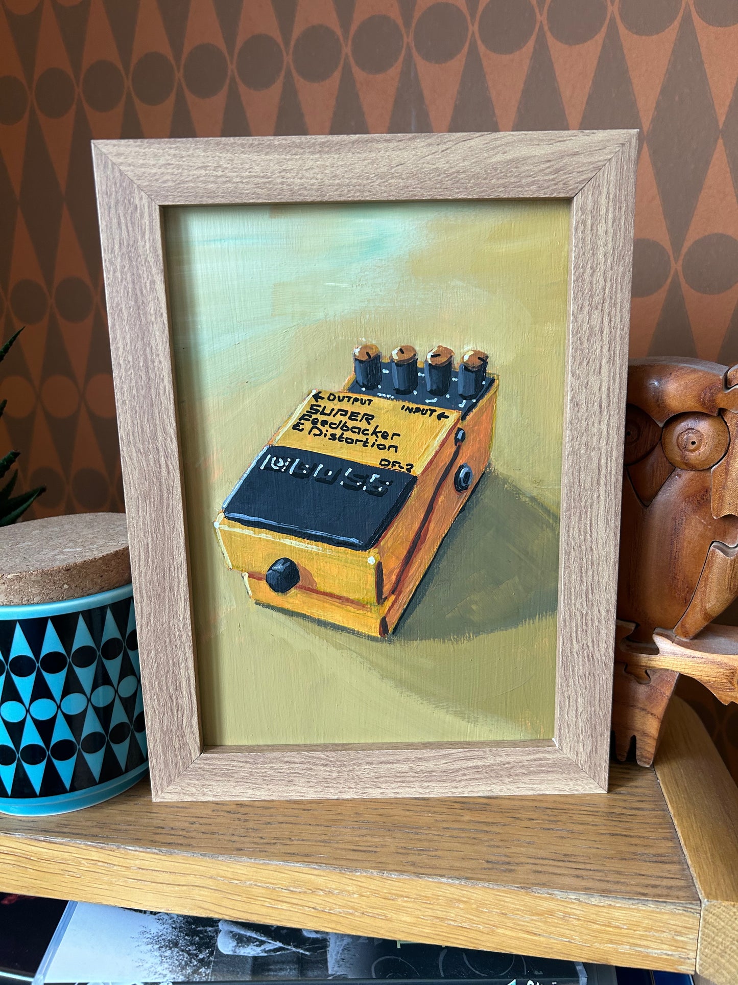 Guitar effects pedal. Painting of Boss Super Feedbacker and Distortion effects pedal. Acrylic on board. Framed. 2025