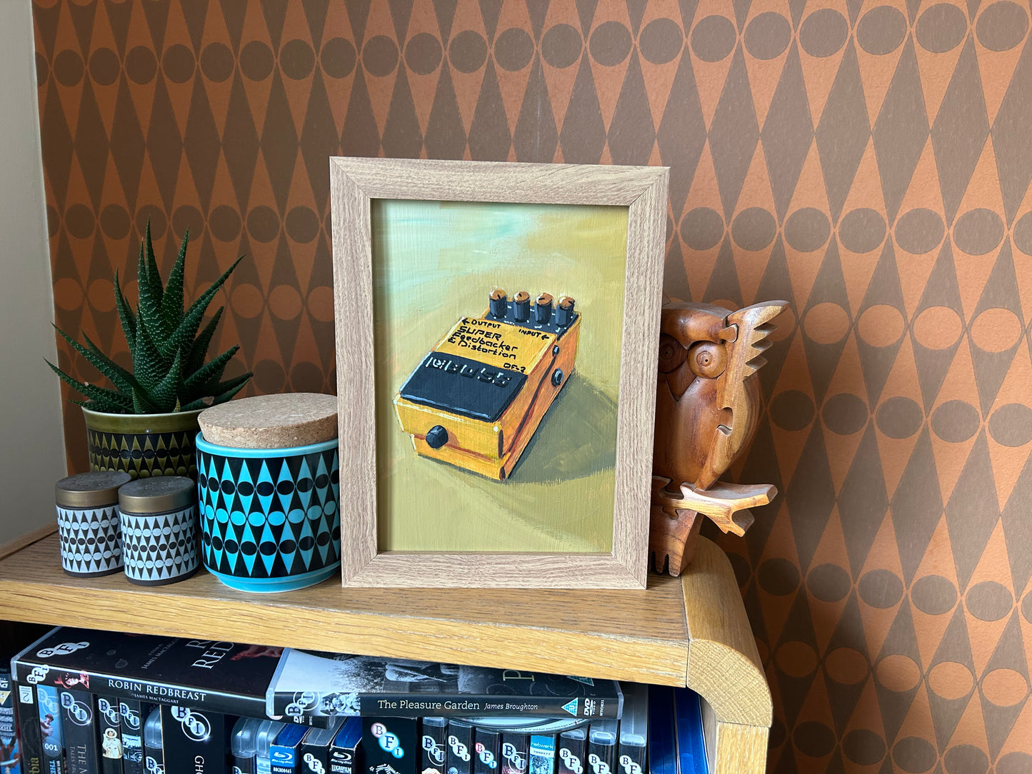Guitar effects pedal. Painting of Boss Super Feedbacker and Distortion effects pedal. Acrylic on board. Framed. 2025