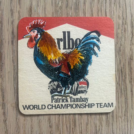 A Gallic Rooster painted onto a Patrick Tambay Malboro World Championship Team beer mat from the 1970s. Beermat painting. Watercolour.