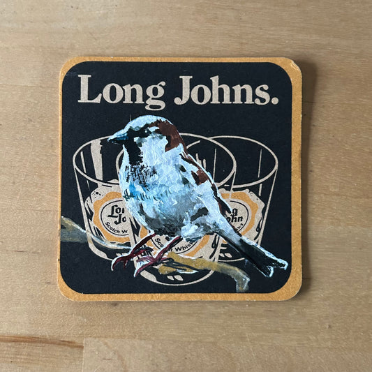 A House Sparrow painted onto a Long John’s Whiskey drinks mat from the 1960s. Beermat painting. Watercolour.