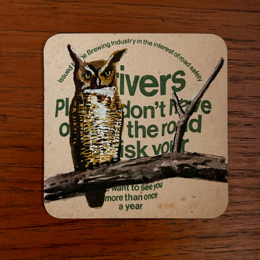 A Great Horned Owl painted onto a drink/drive Trophy beer mat from the 1970s. Beermat painting. Watercolour.