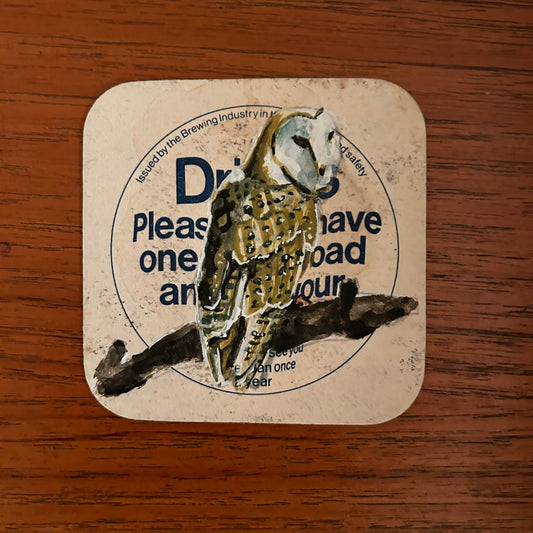 A Barn Owl painted onto a drink/drive Courage beer mat from the 1970s. Beermat painting. Watercolour.
