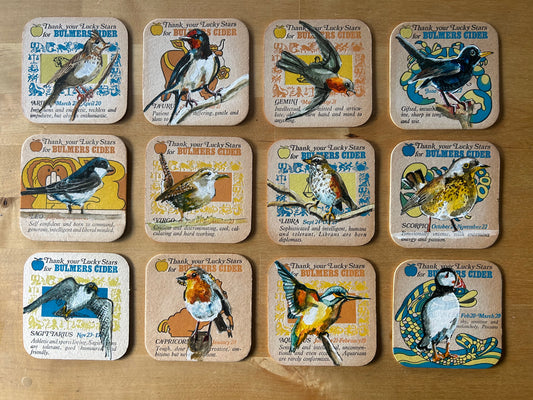 12 birds painted on to 12 1970s Bulmer’s Cider Zodiac drinks mats. Beermat painting. Watercolour.