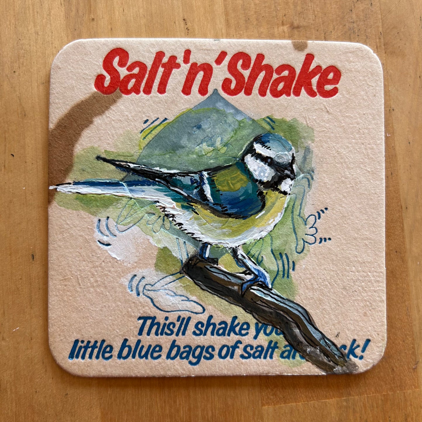 A Blue Tit painted onto a Salt’n’Shake beermat. Beermat painting. Watercolour.