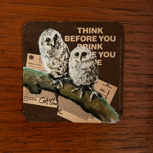 Two Tawny Owlets painted onto a drink/drive Brewmaster Export Ale beer mat from the 1970s. Beermat painting. Watercolour.