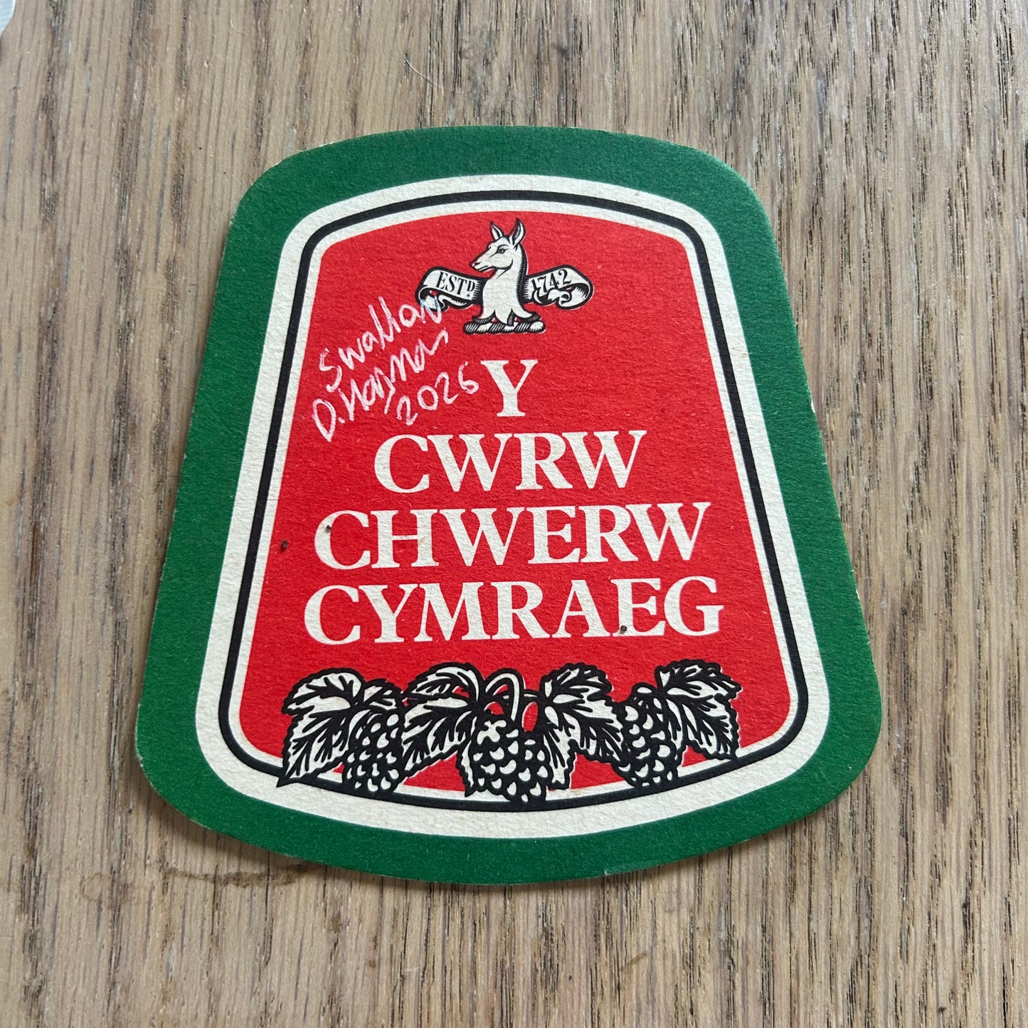 A Swallow painted onto a Welsh Beer drinks mat.  Beermat painting. Watercolour.