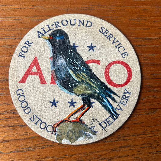 A Starling painted onto a 1950s ‘Anco for all round service’ Beer mat. Beer mat painting. watercolour and acrylic on card.
