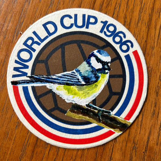 A Blue Tit painted onto a 1966 World Cup beer mat. Beer mat painting. watercolour and acrylic on card.