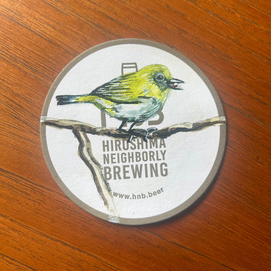 A Japanese White Eye painted on a beer mat from Hiroshima Neighbourly Brewing. Beermat painting. Watercolour.