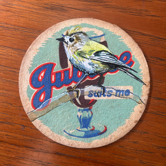 A Gold Crest painted onto a Jubilee Stout beer mat from the 1950s. Beermat painting. Watercolour.