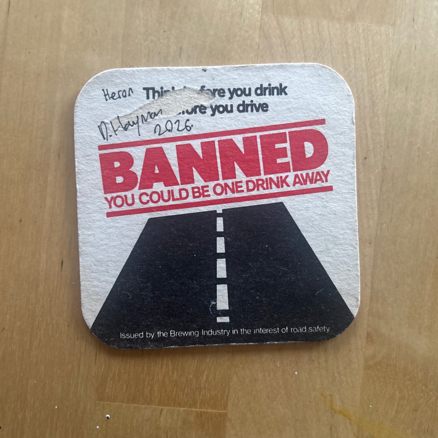 A Heron painted onto a drink drive beer mat from the 1980s. Beermat painting. Watercolour.