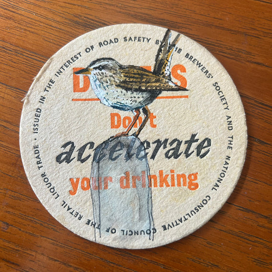 A Wren painted onto a ‘Drivers Don’t Accelerate Your Drinking’ drinks mat from the 1950s. Beermat painting. Watercolour.