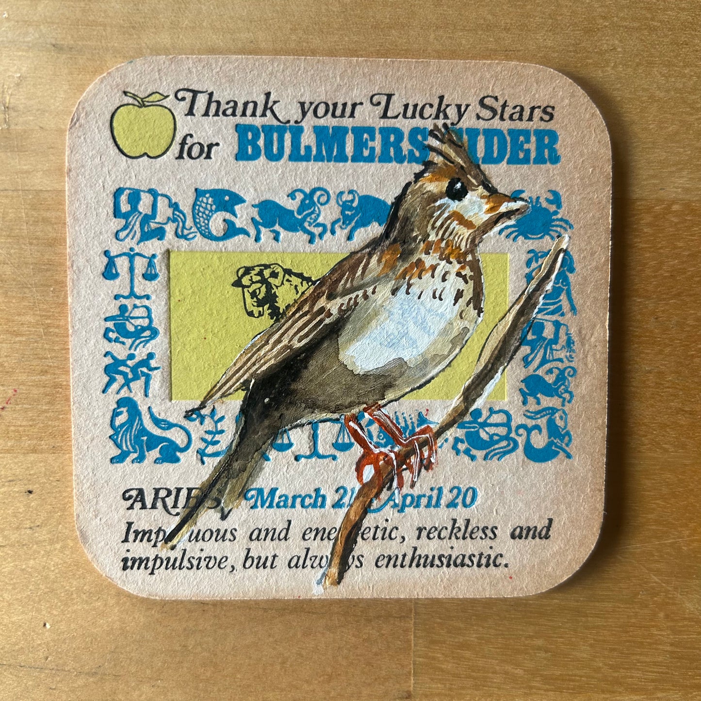 A Skylark painted onto a 1970s Bulmer’s Cider Zodiac drinks mat (Aries). Beermat painting. Watercolour.