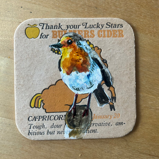 A Robin painted onto a 1970s Bulmer’s Cider Zodiac drinks mat (Capricorn). Beermat painting. Watercolour.