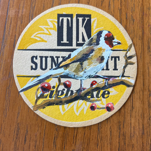 A Goldfinch painted onto a ‘’Sunbright Light Ale” Beer Mat from the 1960s. Beer mat painting. watercolour and acrylic on card.