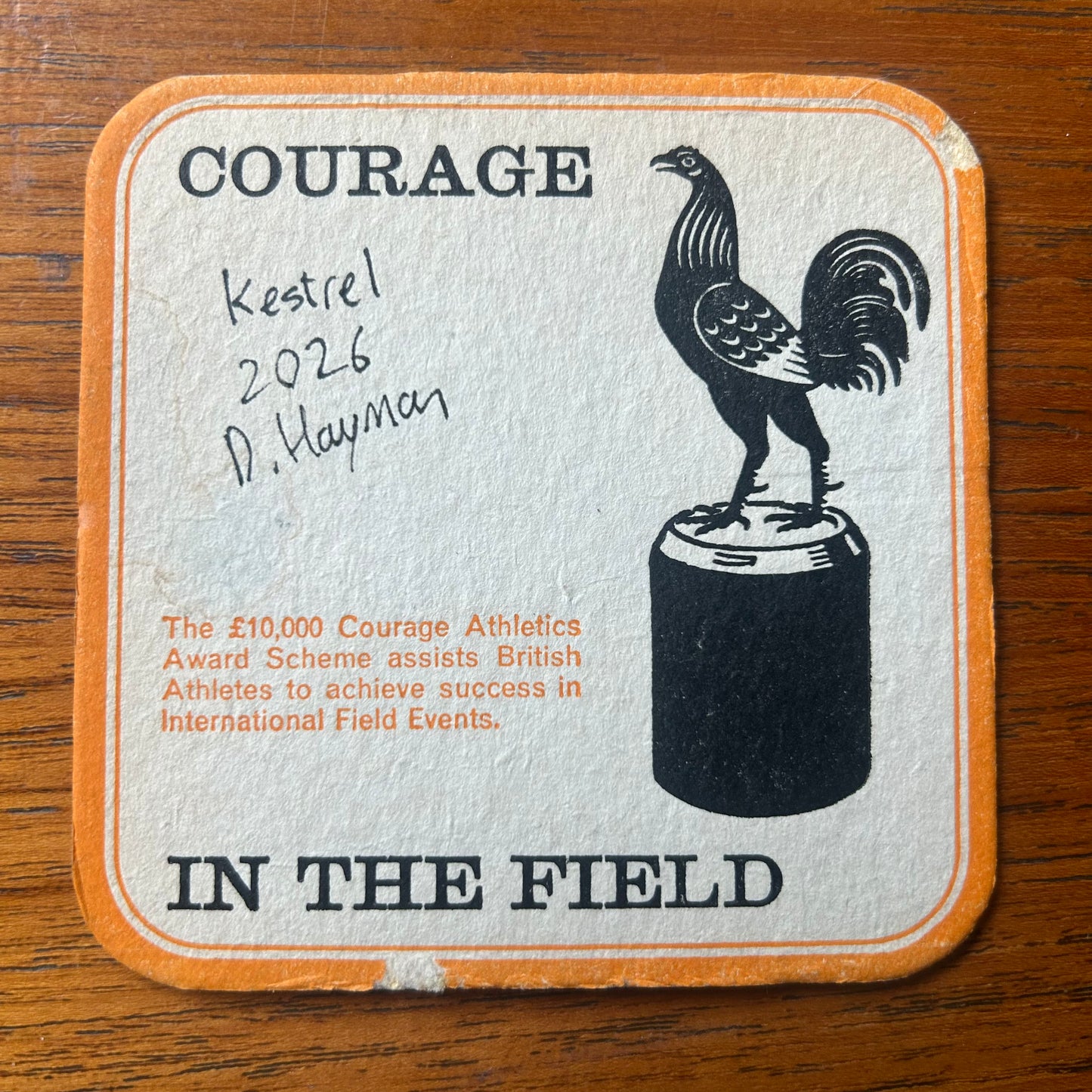A Kestrel painted onto a Courage Beer ‘In The Field’ athletics beer mat from 1964. Beermat painting. Watercolour.