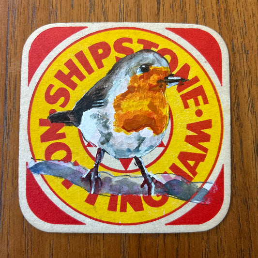 A Robin painted onto a ‘’Shipstone Nottingham” Beer Mat from the 1960s. Beer mat painting. watercolour and acrylic on card.