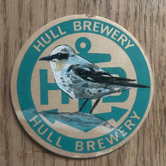 A Wheatear painted onto a Hull Brewery beer mat from 1970. Beermat painting. Watercolour.