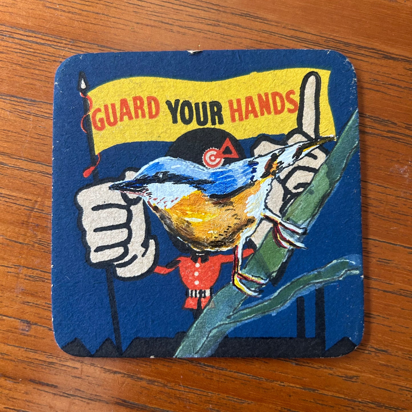 A Nuthatch painted onto a ‘Guard Your Hands’ drinks mat from the 1950s. Beermat painting. Watercolour.