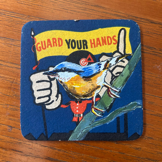 A Nuthatch painted onto a ‘Guard Your Hands’ drinks mat from the 1950s. Beermat painting. Watercolour.