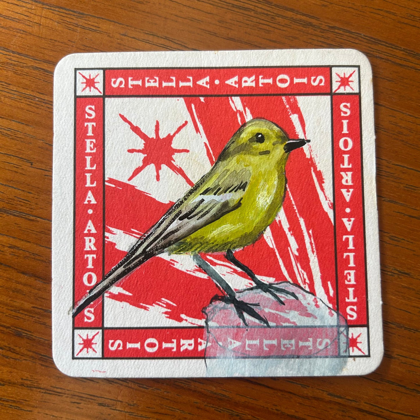 A Yellow Wagtail painted onto a ‘Stella Artois’ drinks mat. Beermat painting. Watercolour.