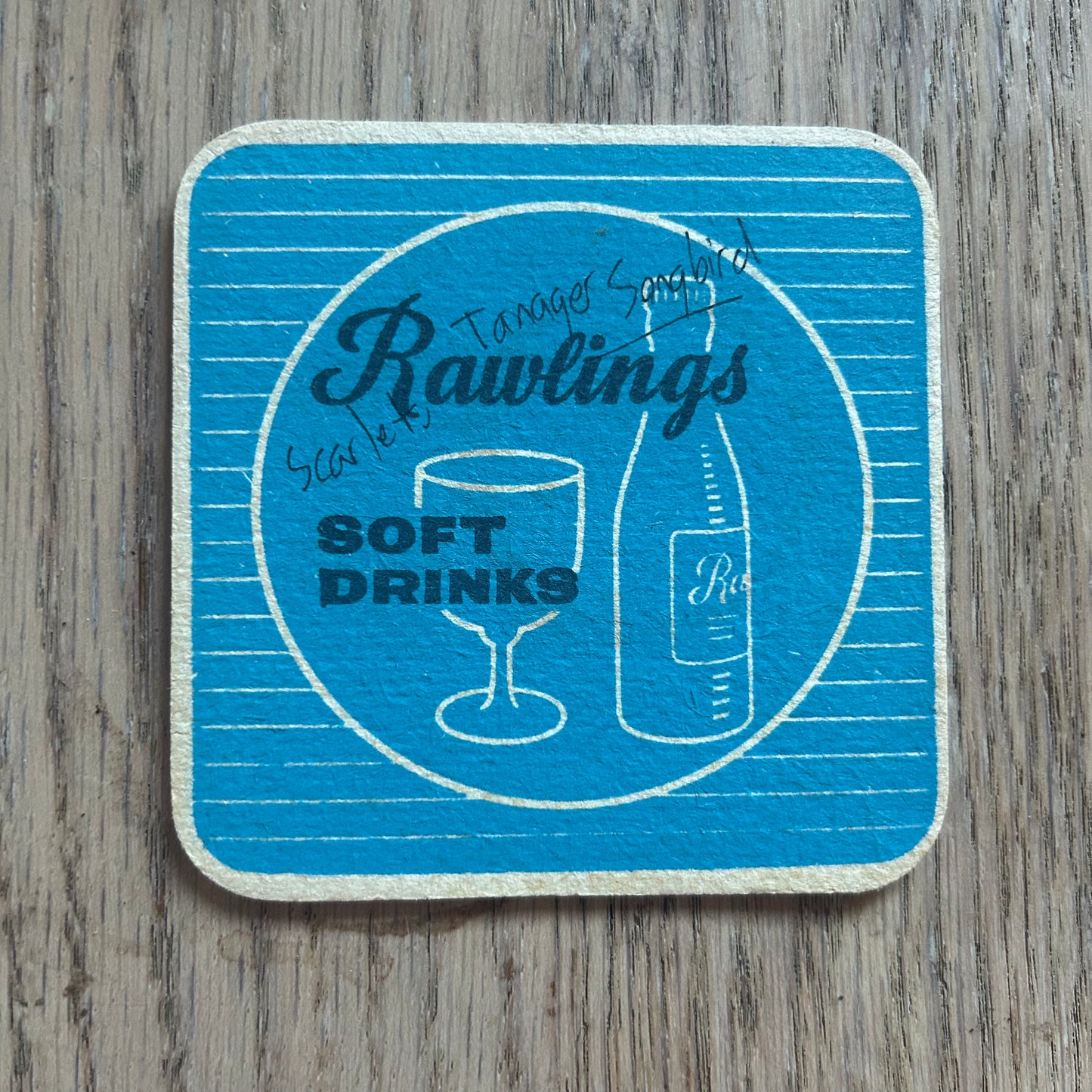 A Scarlet Tanager Songbird painted onto a Rawlings soft drinks mat from the 1950s. Beermat painting. Watercolour.