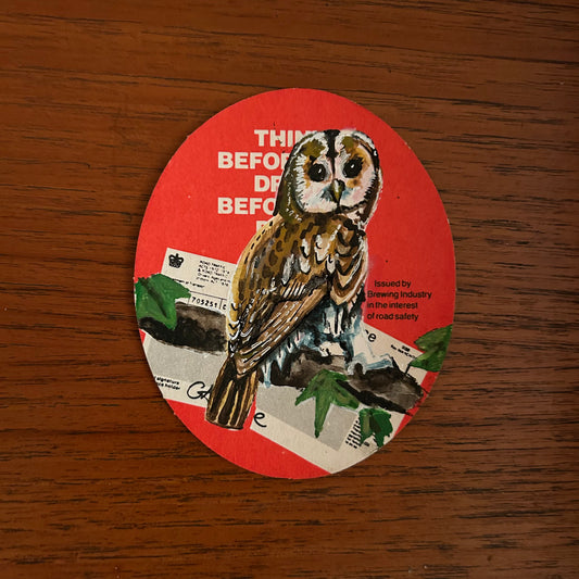 A Tawny Owl painted onto a drink/drive Whitbread beer mat from the 1970s. Beermat painting. Watercolour.