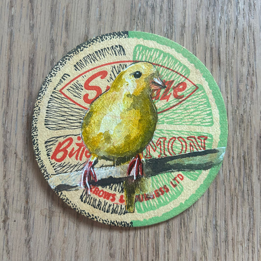 A Canary painted onto a Sunblaze Bitter Lemon drinks mat from the 1950s. Beermat painting. Watercolour.