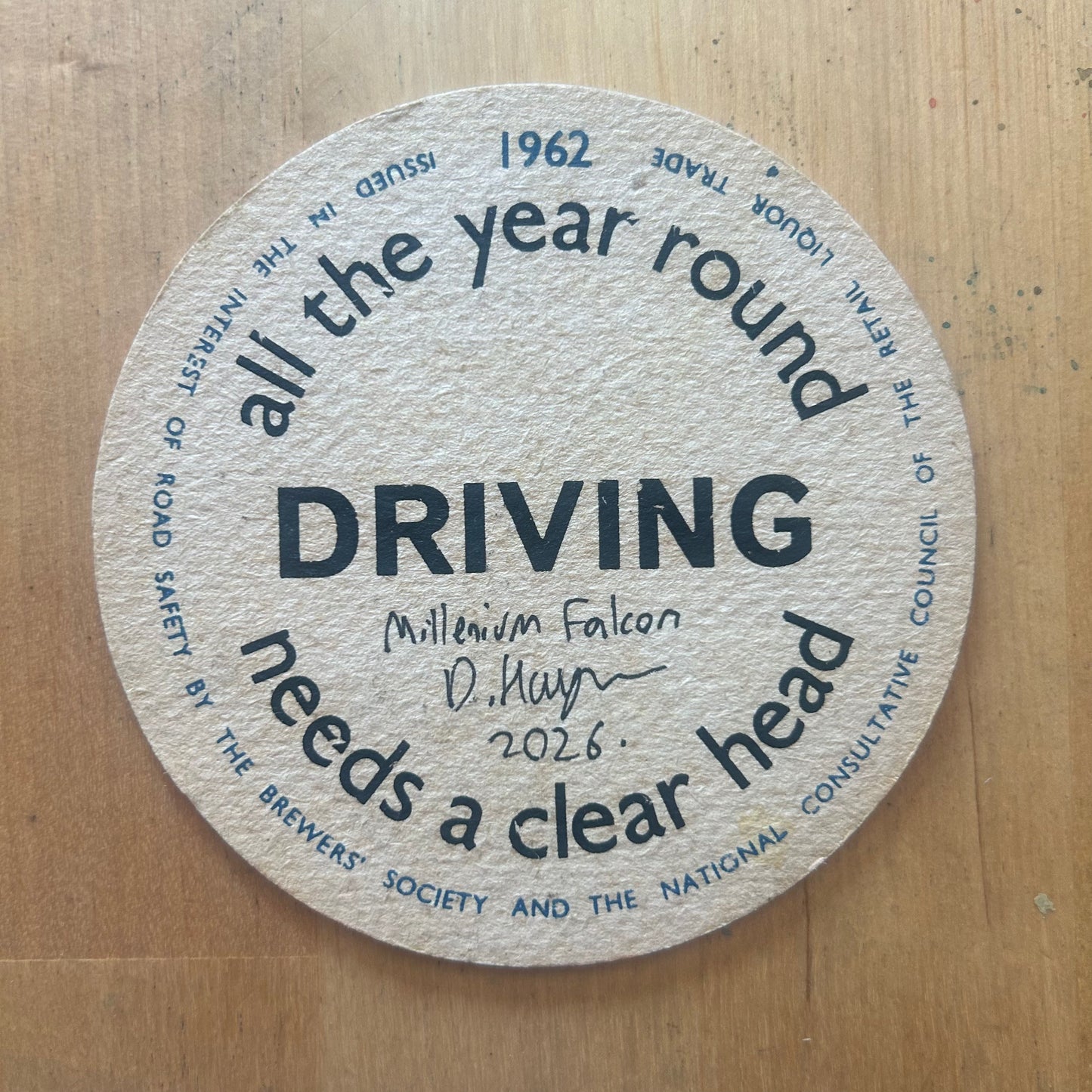 The Millenium Falcon painted on a ‘Driving All The Year Round Needs a Clearer Head’ Beermat from 1962. Beermat painting. Watercolour.
