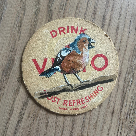 A Chaffinch painted onto a Vimto drinks mat from the 1950s. Beermat painting. Watercolour.