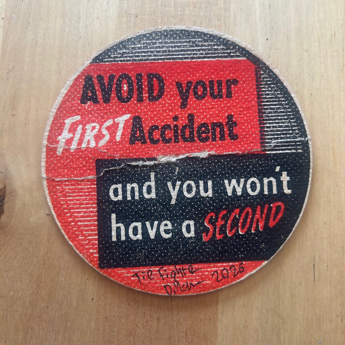 A Tie Fighter painted on a ‘Avoid Your First Accident’ Beermat from the 1950s. Beermat painting. Watercolour.