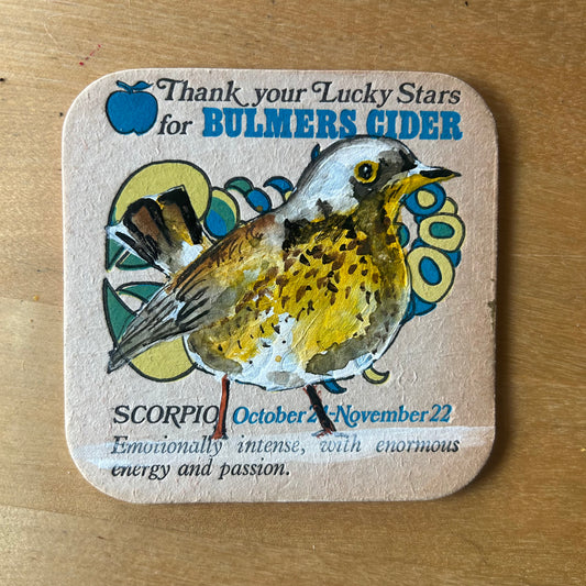 A Fieldfare painted onto a 1970s Bulmer’s Cider Zodiac drinks mat (Scorpio). Beermat painting. Watercolour.