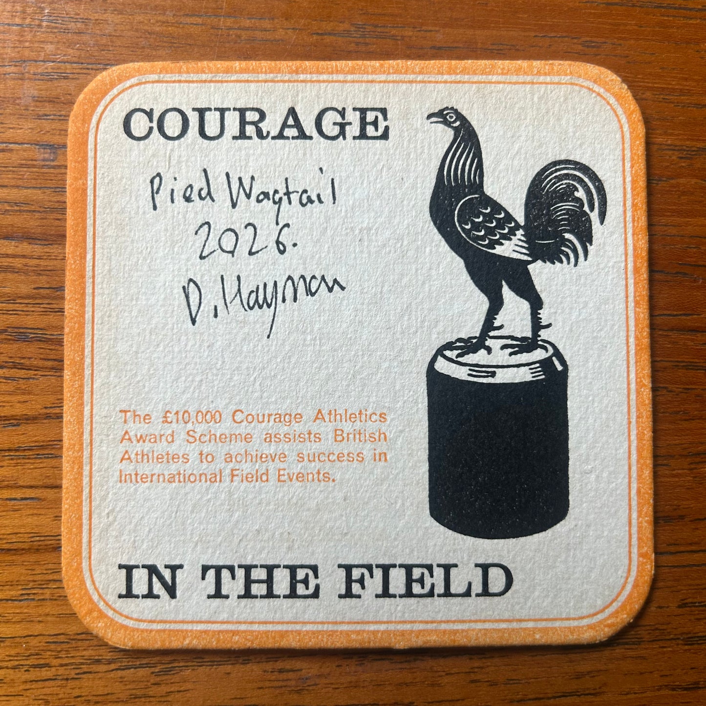 A Pied Wagtail painted onto a Courage Beer ‘In The Field’ athletics beer mat from 1964. Beermat painting. Watercolour.