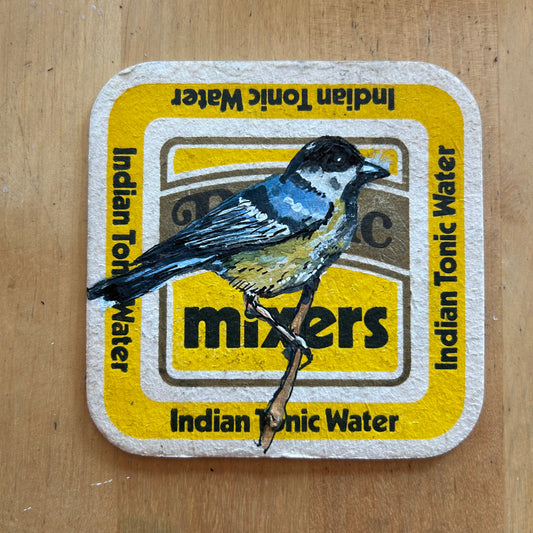 A Great Tit painted onto a Britvic mixers drinks mat. Beermat painting. Watercolour.