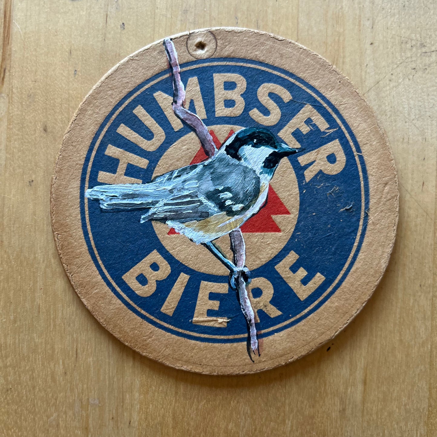 A Coal Tit painted onto a Humbser Biere drinks mat from the 1950s. Beermat painting. Watercolour.