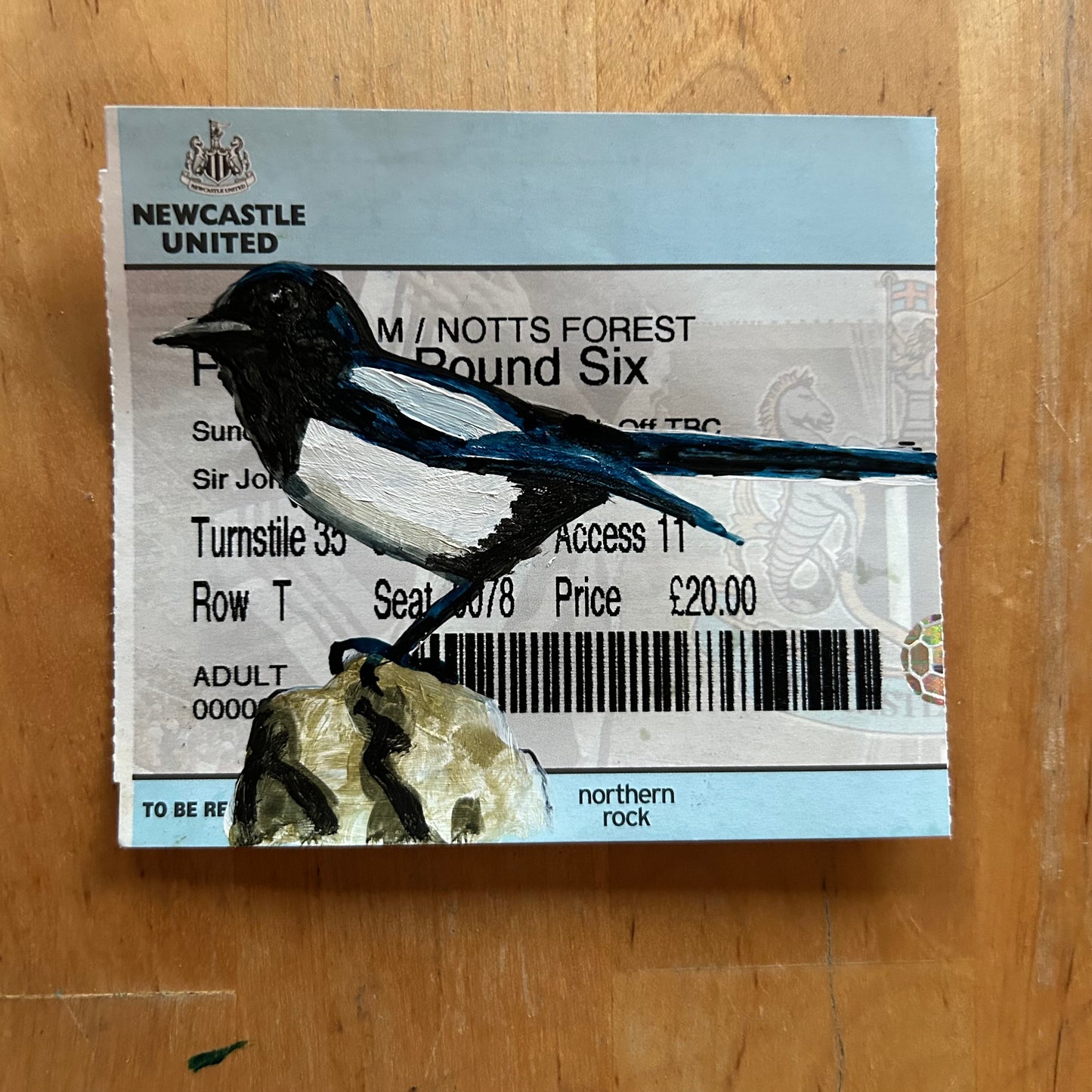 A magpie painted onto a football ticket Newcastle United FA Cup Round Six 2005. Watercolour.