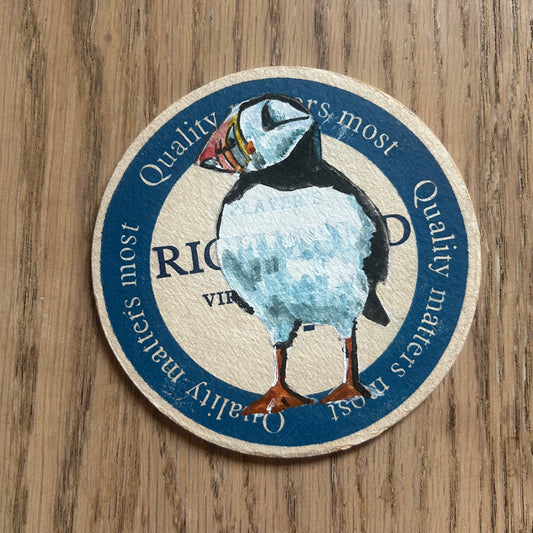 A Puffin painted onto a Players Richmond cigarettes drinks mat from the 1950s. Beermat painting. Watercolour.