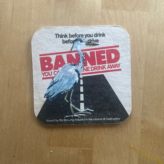 A Heron painted onto a drink drive beer mat from the 1980s. Beermat painting. Watercolour.