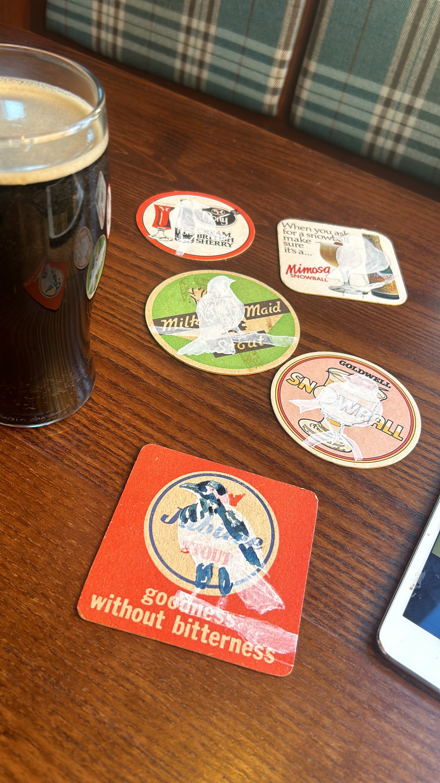 A Raven painted onto a Jubilee Stout beer mat from the 1960s. Beermat painting. Watercolour.