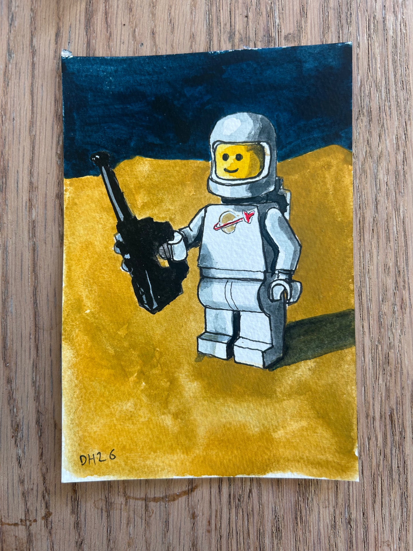 ‘I Can Hear Heaven’ Postcard painting of a Lego Spaceman figure 1978.