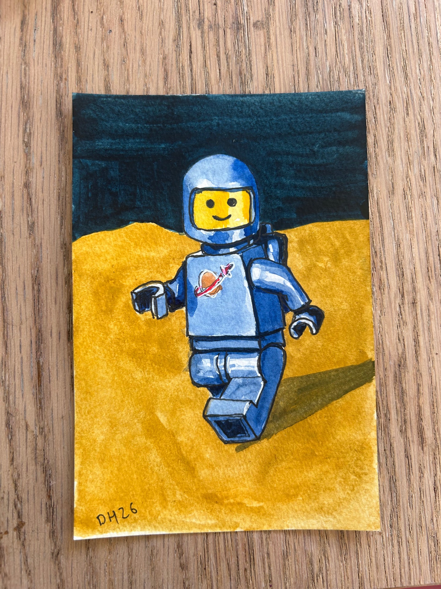 ‘Don’t worry I see you’ Postcard painting of a Lego Spaceman figure 1982.